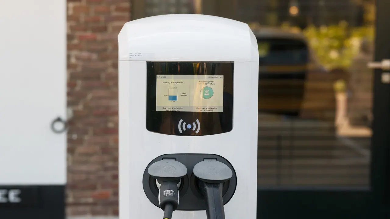 Two charging cables connected to a modern electric vehicle charging station